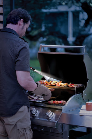 A man using a Grillight LED Spatula as he barbeques
