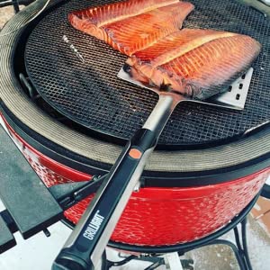 A Giant Edition Grillight LED Spatula being used to grill salmon